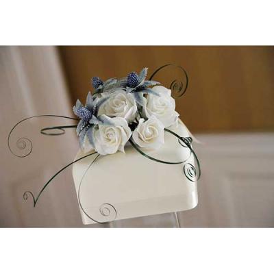Top tier decorated with sugar thistles and ivory roses.