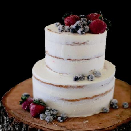 Two tier semi-naked wedding cake with fresh berries