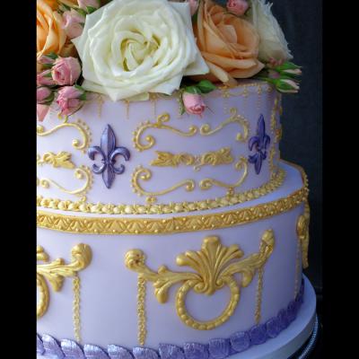 Elaborate scroll work icing and Fleur de Lys