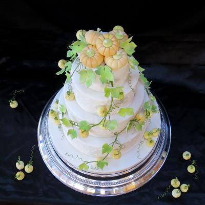 Sugarcraft Pumpkins spill from the top tier.
