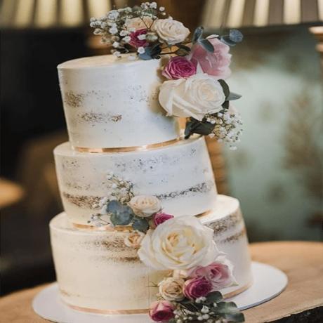 sRose bouquet three tier semi-naked wedding cake.