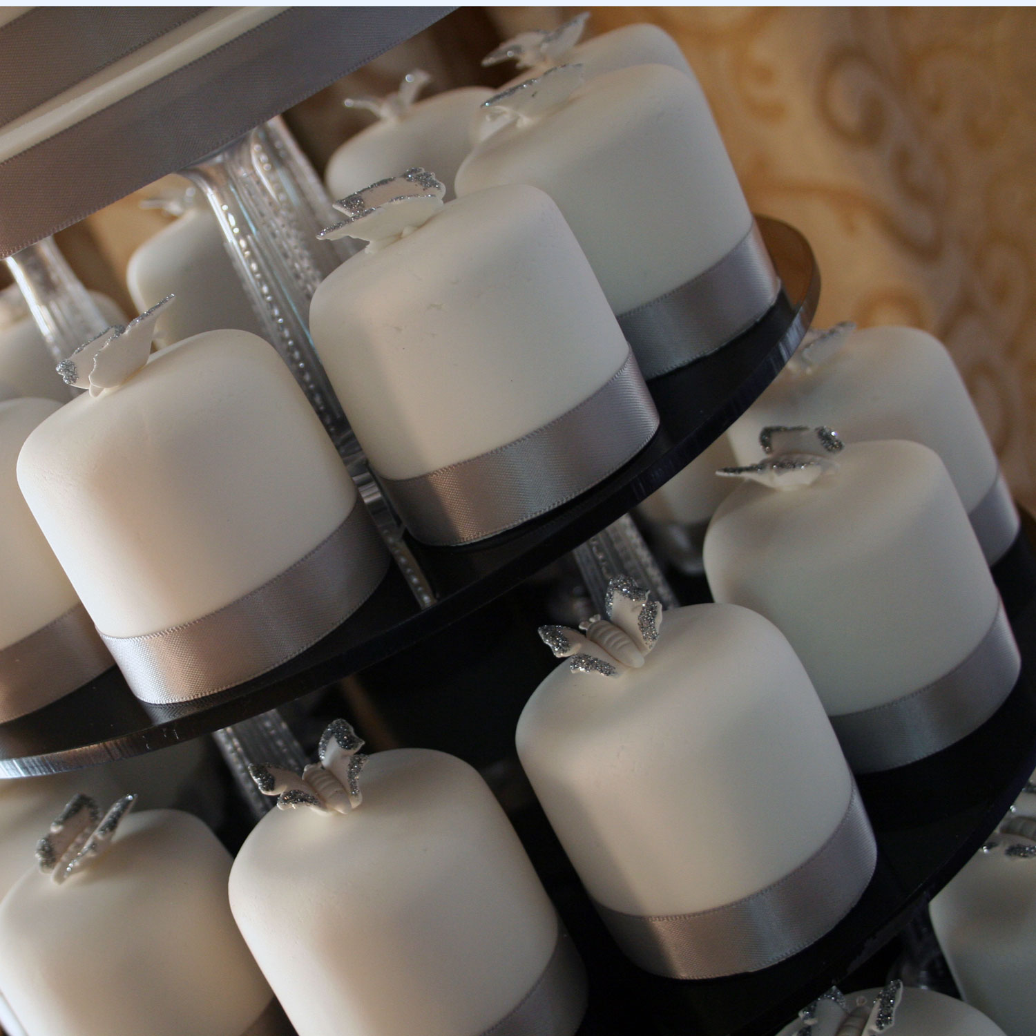 Individually iced Mini Cakes trimmed wih Silver Ribbon